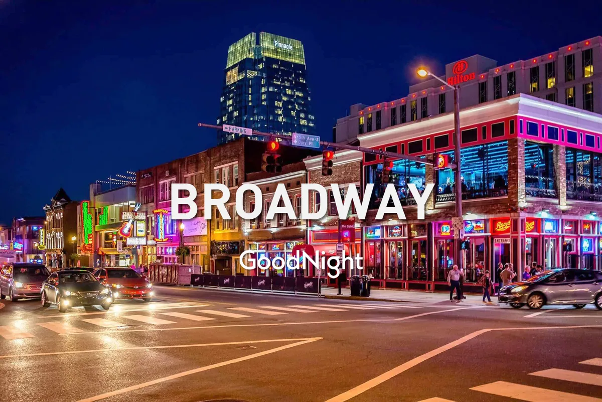 An exterior street scene on a bustling Nashville evening, with bright neon signs, a busy sidewalk, and people enjoying live music, dining, and nightlife. The energy of the crowd and lights reflects the city’s vibrant entertainment scene.