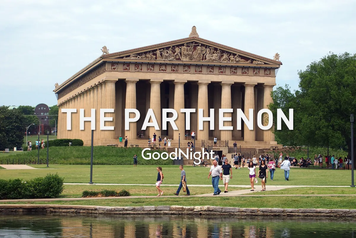 A sunny day scene at Centennial Park, featuring the iconic Parthenon, visitors enjoying the lush green lawn, and water reflections. Groups of people are sightseeing, strolling, and taking photos, creating a lively and welcoming atmosphere.