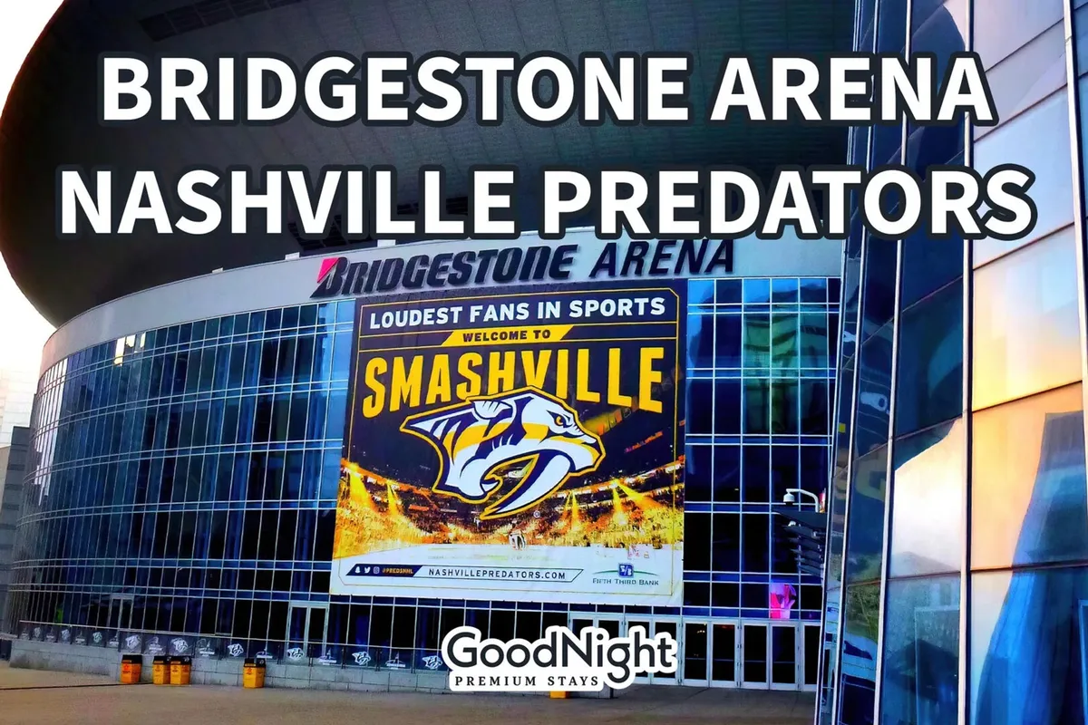 A dynamic exterior shot of Bridgestone Arena adorned with the Nashville Predators signage and the energetic 'Smashville' banner. The arena is surrounded by crowds and bright city lights, highlighting its status as a major hub for live concerts, sports, and entertainment just steps from the main downtown scene.